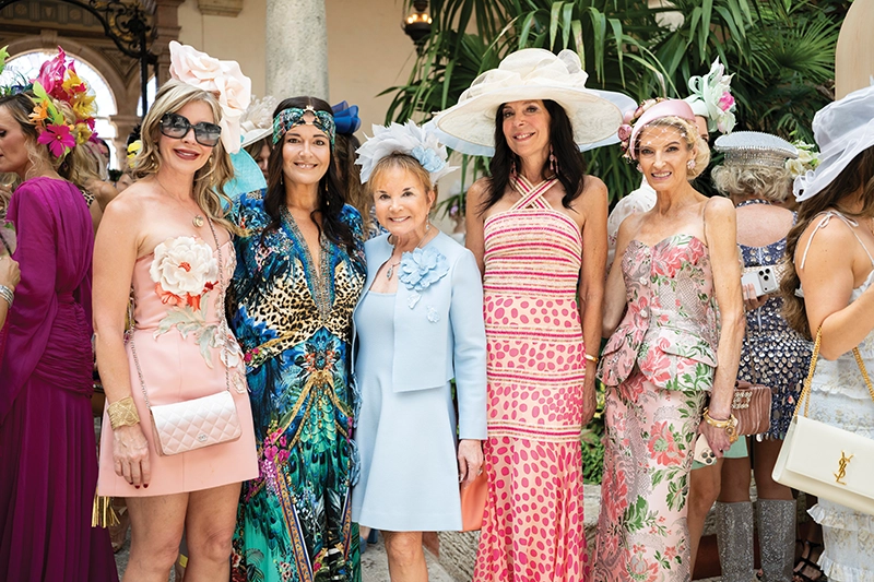 Group of women wearing elaborate hats.