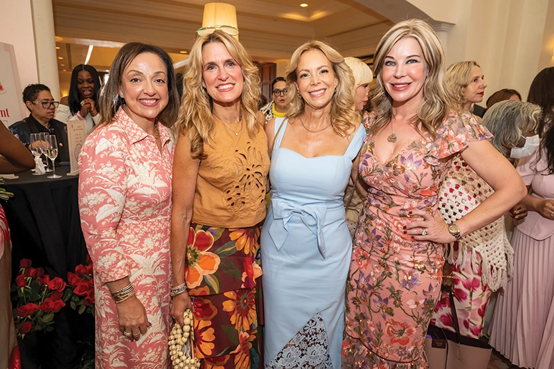 Four women smiling.
