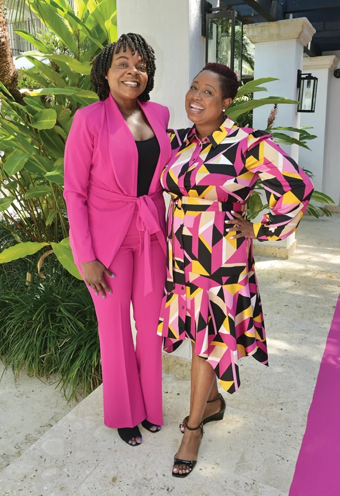 Two women in front of plants.