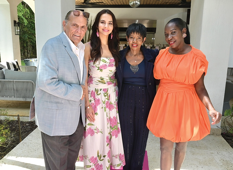 A man and three women smiling.